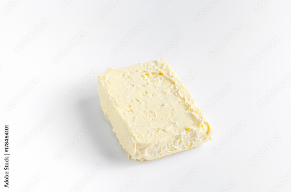 A piece of butter on white A piece of butter on white