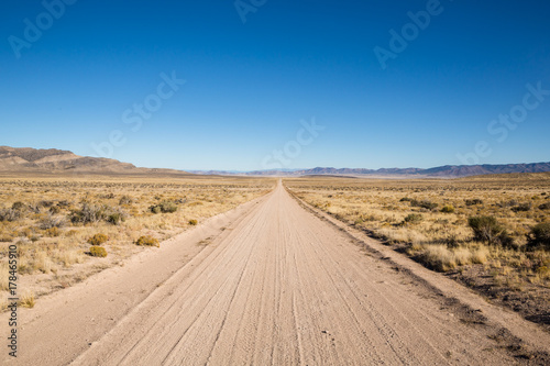 Long  desolate dirt road in te Utah desert.