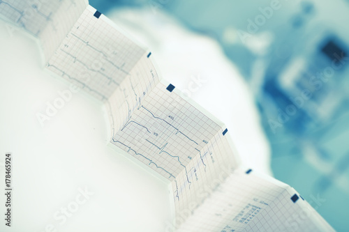 Folded ECG trace in the background of patient bed photo