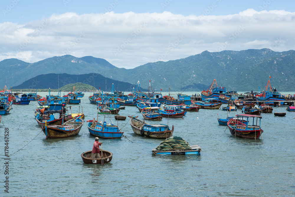 Traditional old wooden Vietnamese boats and round fishing boats Thung Chai. Local woven bamboo basket boats or coracle moored near harbour. Vietnam