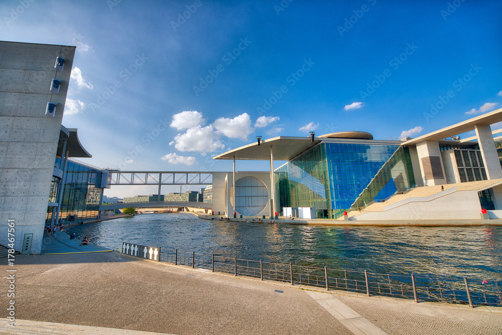 Fototapeta premium BERLIN, GERMANY - JULY 25, 2016: Modern buildings along Spree River near Bundestag. Berlin attracts 15 million tourists annually