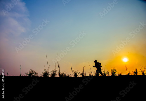 Boy walking on the meadow at sunset © EKKAPON