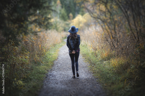 girl in autumn bridge with hat