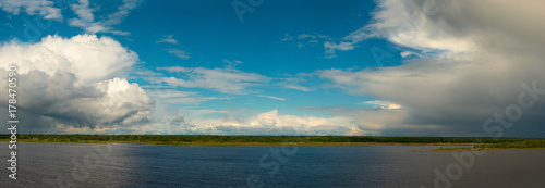 Clouds over the river. Panorama
