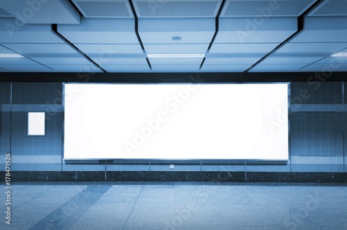 Fototapeta Naklejka Na Ścianę i Meble -  blank advertising billboard or light box with copy space for your text message or media content in subway train station or airport, information board, commercial, marketing concept, blue tone color