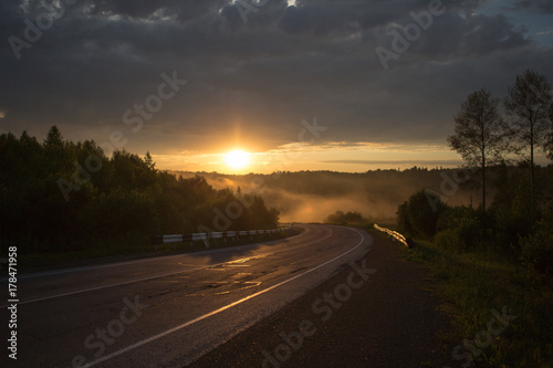 The curve of the road in the mountains. Sunset