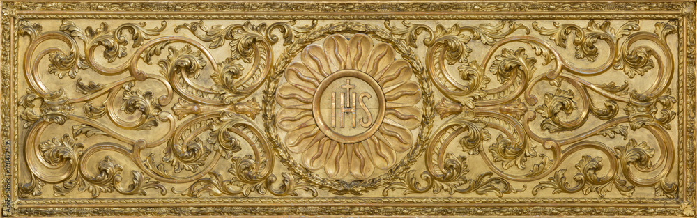 LONDON, GREAT BRITAIN - SEPTEMBER 18, 2017: The carved polychrome baroque relief with the IHS initials on the altar in church Our Lady of the Assumption by unknown artist.
