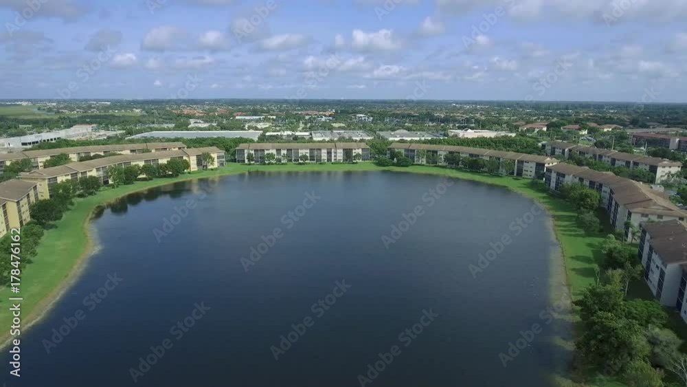 Aerial shot of a lake surrounded by homes in a rural neighborhood Aerial shot of a lake surrounded by homes in a rural neighborhood