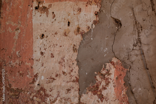 Rustic wall plaster in corelpinks and soft browns forming a textured background