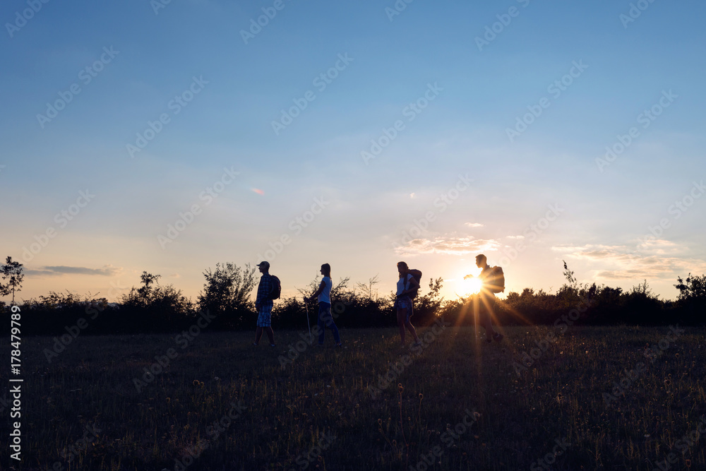 Fototapeta premium Hikers with backpacks walking at nature