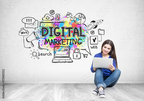 Teenage girl in jeans, a laptop, digital marketing photo