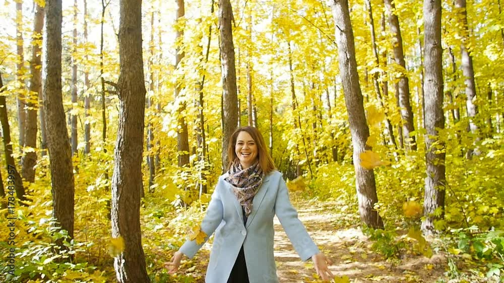 Young happy Woman Throwing Autumn Leaves Young happy Woman Throwing Autumn Leaves