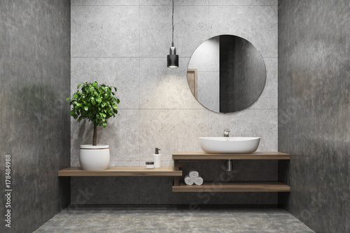 Concrete bathroom, sink, round mirror