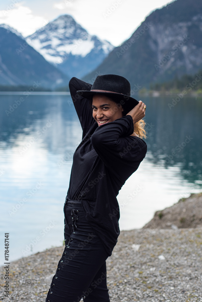 Beautiful Girl enjoys scenic mountain view at lake Plansee in Austria