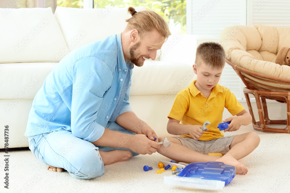 Father playing with cute son at home Father playing with cute son at home