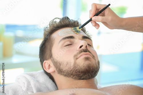 Beautician applying scrub o...