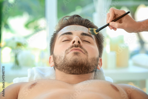 Beautician applying scrub o...