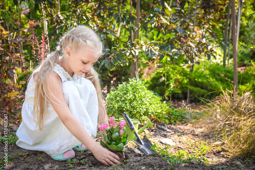 Cute little girl planting f...