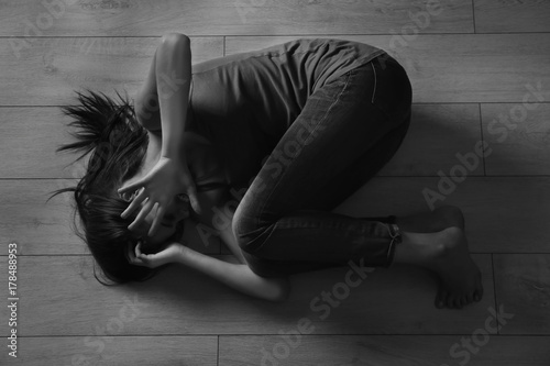 Battered young woman lying ...