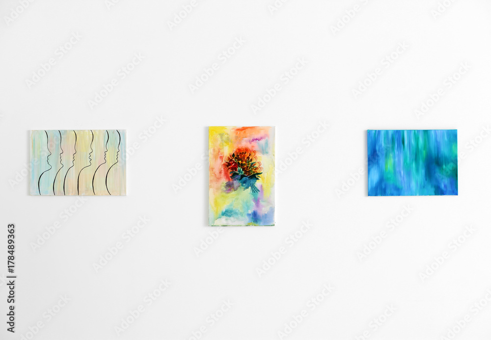 Naklejka premium Beautiful paintings on white wall in art gallery