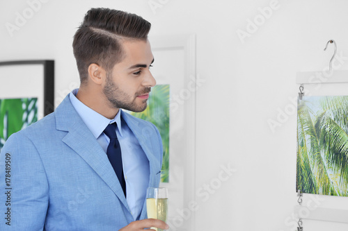 Young man looking at pictur...