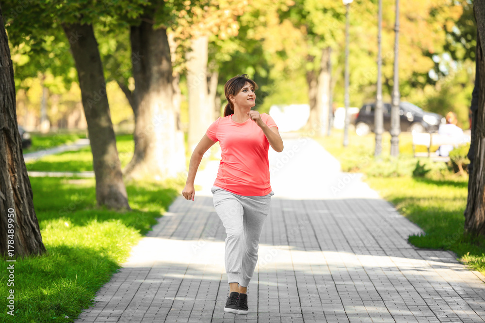 Mature woman running in park Mature woman running in park