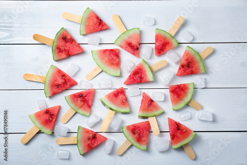 Slices of ripe watermelon on color wooden background