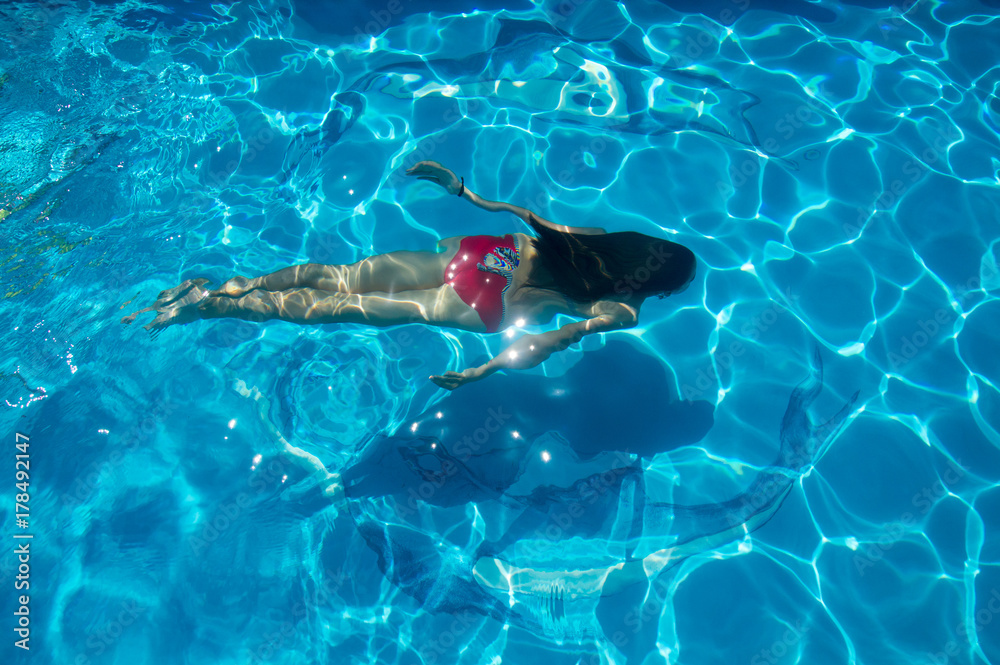 The girl swims under the water