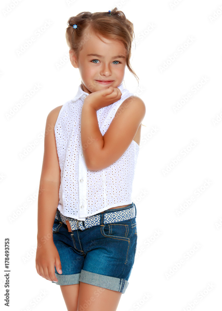 Fototapeta premium A little girl in shorts and a white shirt.
