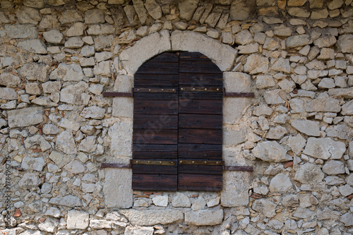 antique window shutters made of wood, antique natural stone wall, detail restored house, Central Italy