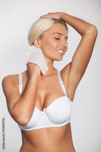 Woman cleaning neck with wet wipes