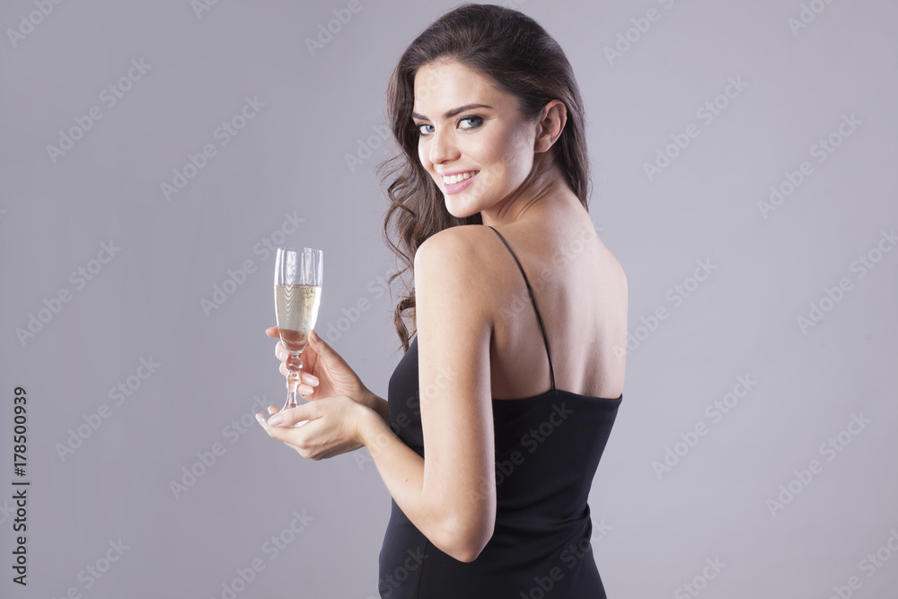 Happy New Year! Woman in black dresses drinking a champagne. Happy New Year! Woman in black dresses drinking a champagne.