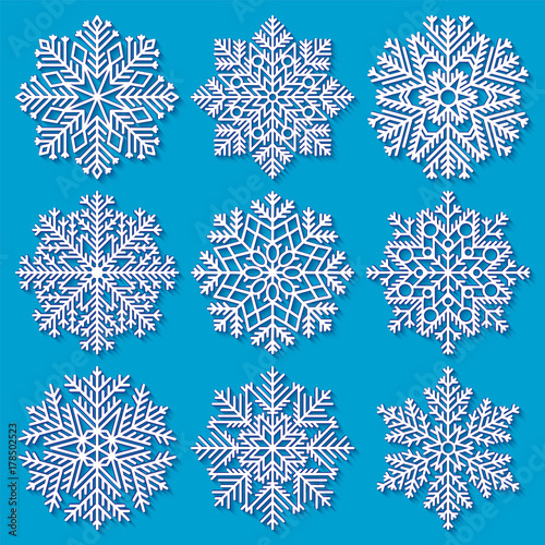 Set of white highly detailed geometrical snowflakes on blue background. Vector illustration