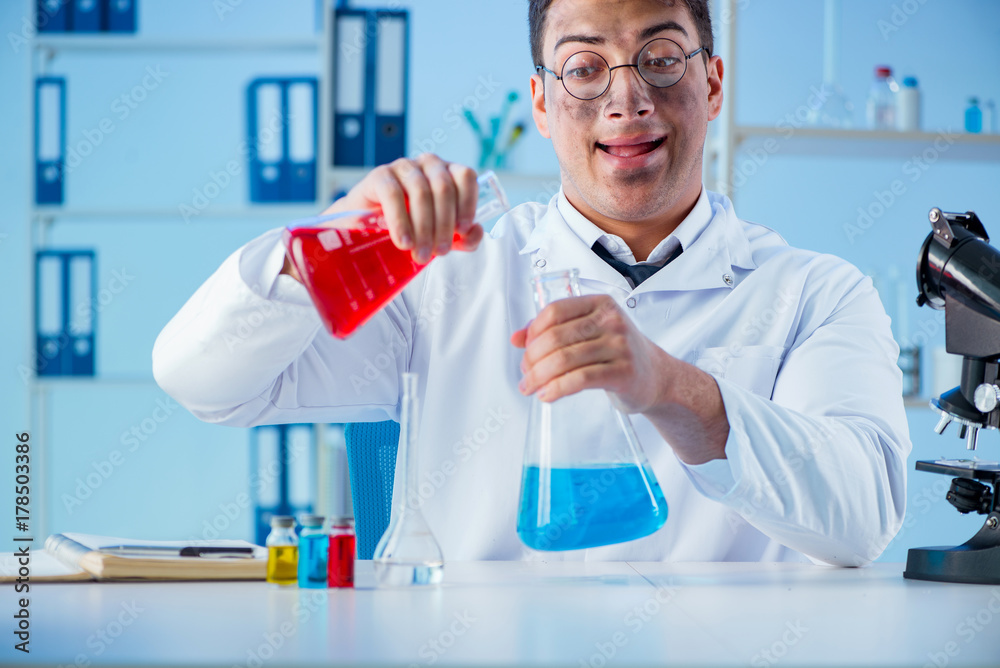 Funny mad chemist working in a laboratory Funny mad chemist working in a laboratory