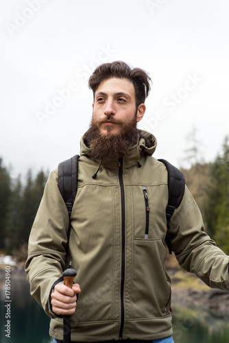 Hipster Adventurer hikes along Lake Obernberg in the mountains of Austria © benicoma
