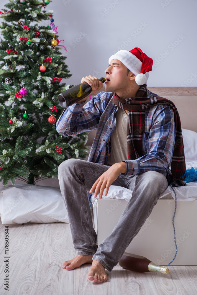 Fototapeta premium Man suffering hangover after christmas party