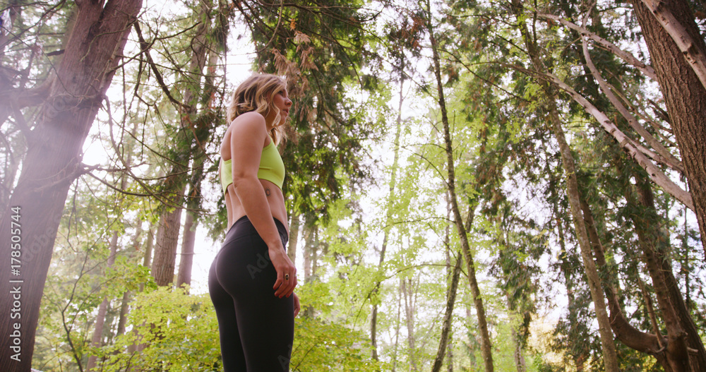 Runner Woman In Woods Exercising Outdoors Resting under trees