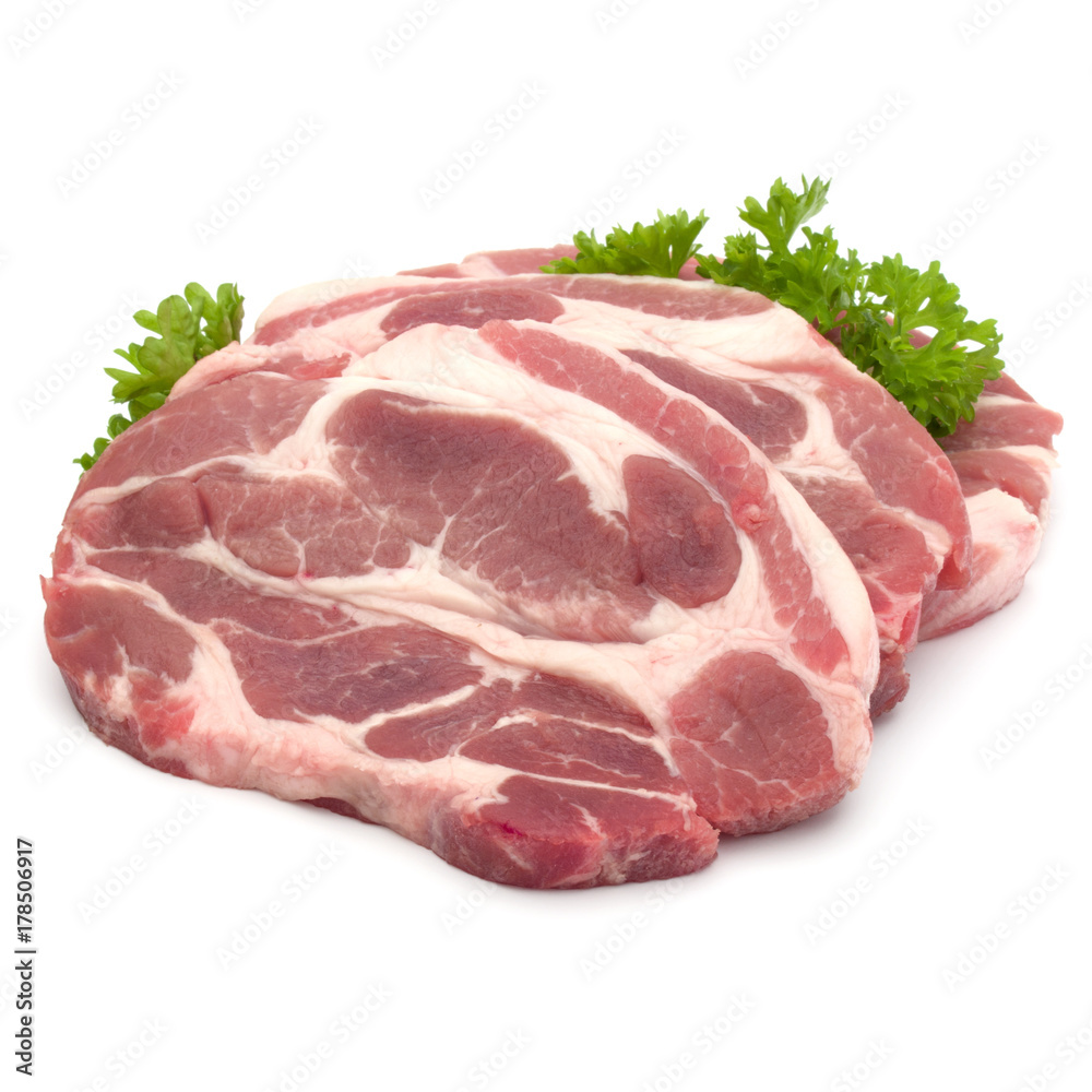 Raw pork neck chop meat with parsley herb leaves garnish isolated on white background cutout Raw pork neck chop meat with parsley herb leaves garnish isolated on white background cutout