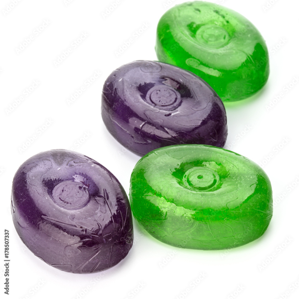 Four colorful fruit hard sugar candies, boiled sweeties or sugar plums isolated on white background cutout Four colorful fruit hard sugar candies, boiled sweeties or sugar plums isolated on white background cutout