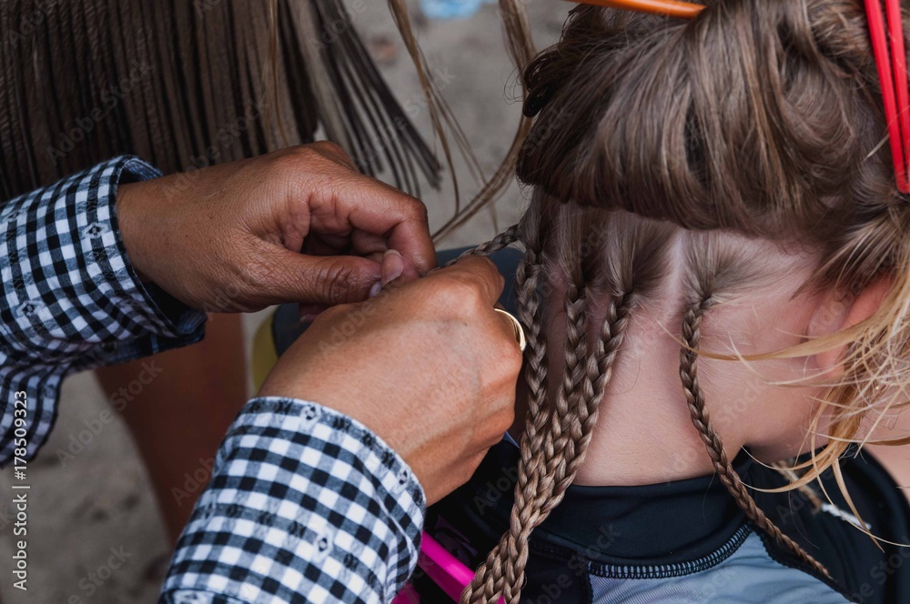 Fototapeta premium girl braids on the beach