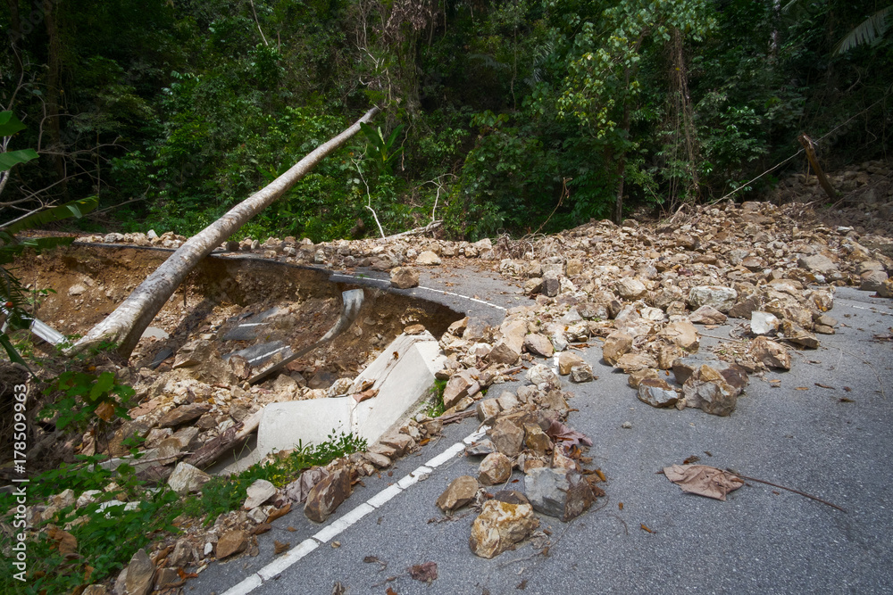 Rock slide collapse after a mudflow on a mountain road in a rural area Rock slide collapse after a mudflow on a mountain road in a rural area