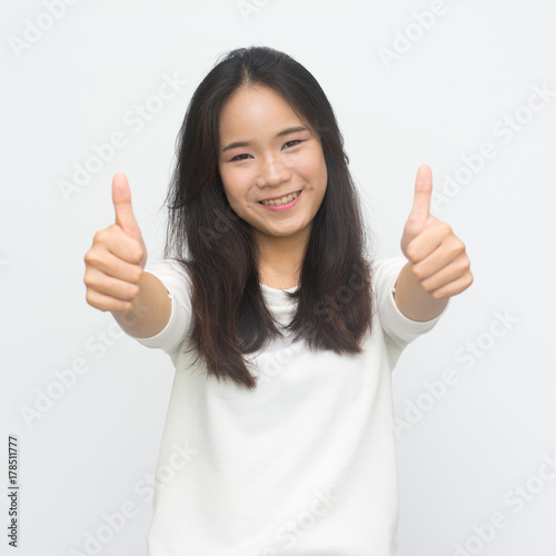 Happy young woman giving thumbs up isolated on white  background © joloei