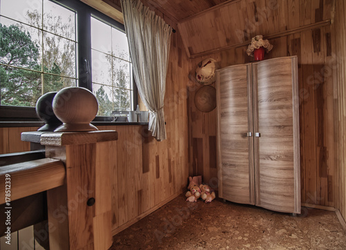 rustic wooden hallway with the window and wardrobe in small house