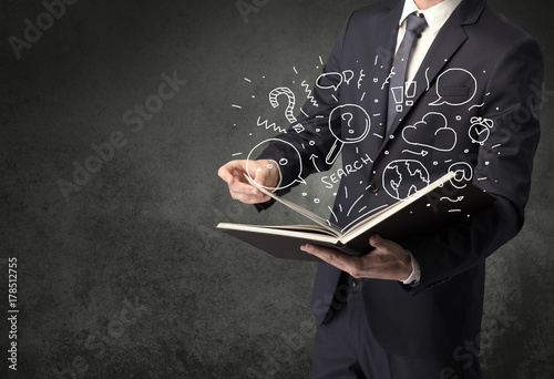 Businessman holding a book.