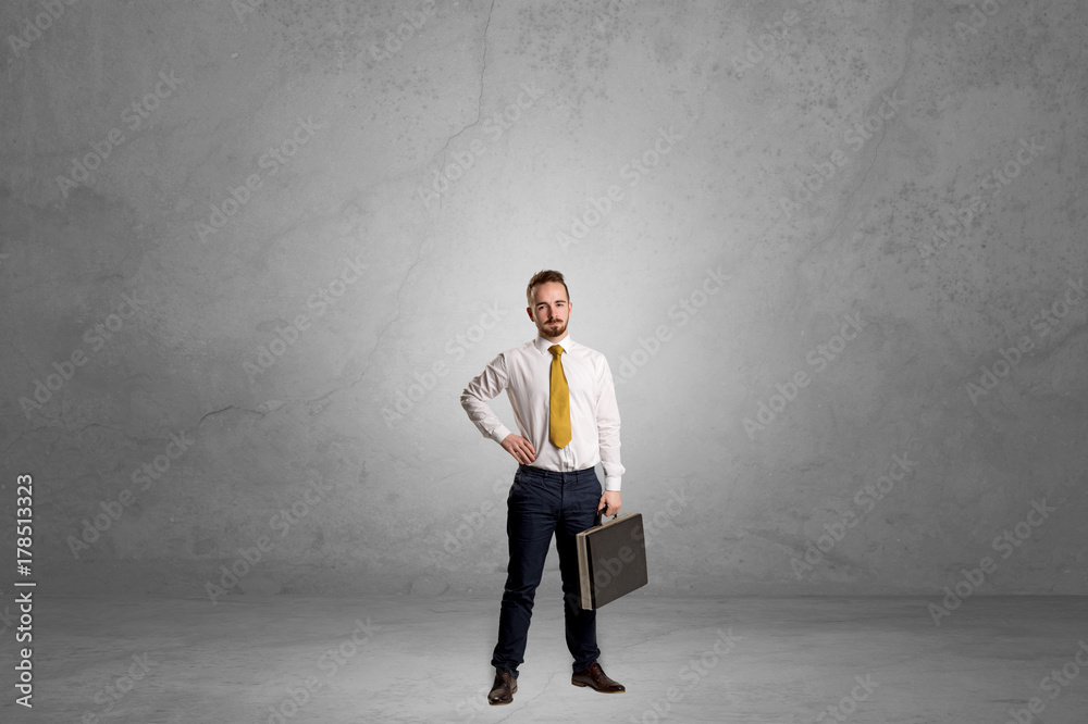 Alone businessman standing in a dark room Alone businessman standing in a dark room