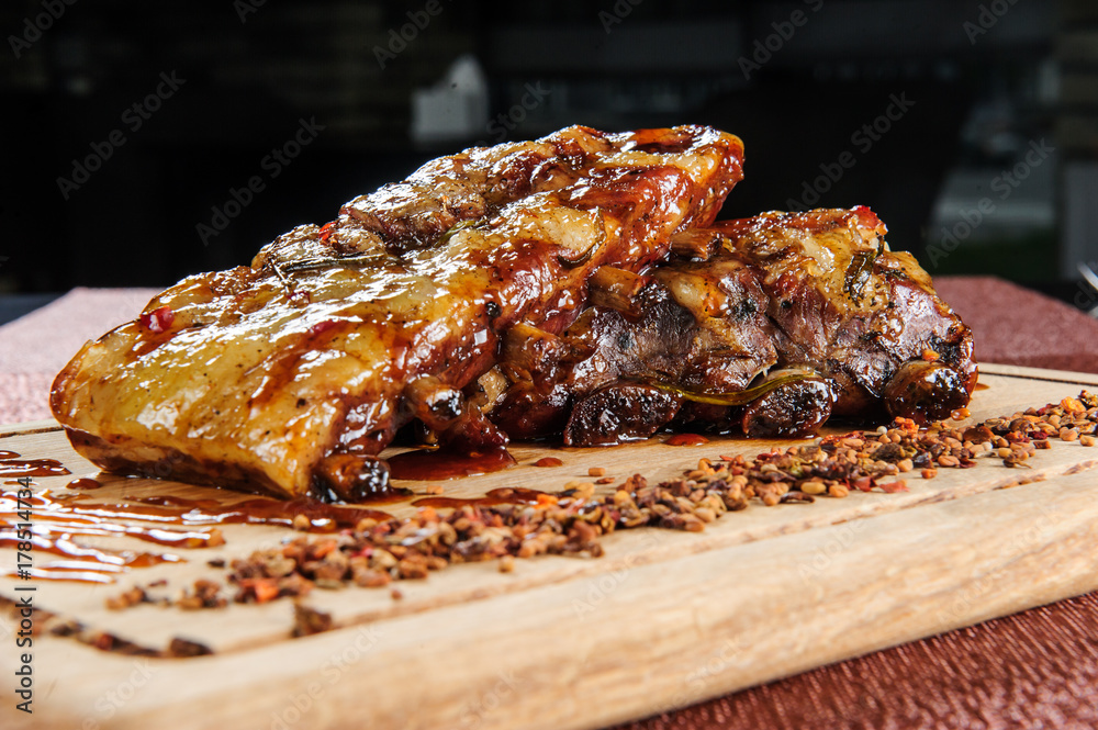 Grilled pork meat steak on wooden cutting plate over wooden table.European food.
