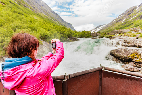 Tourist woman by Videfossen Waterfall in Norway photo