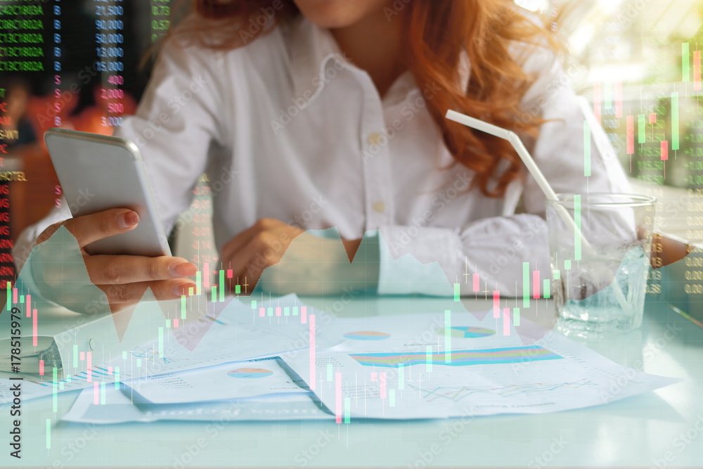 Multi exposure image of hands of confident business woman holding mobile phone in office with stock market price chart. Investment growth concept