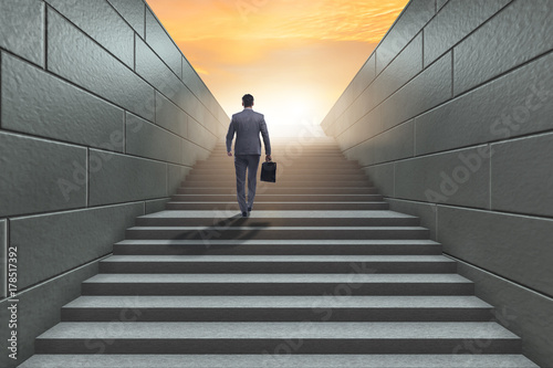 фотографія Businessman climbing up challenging career ladder in business co