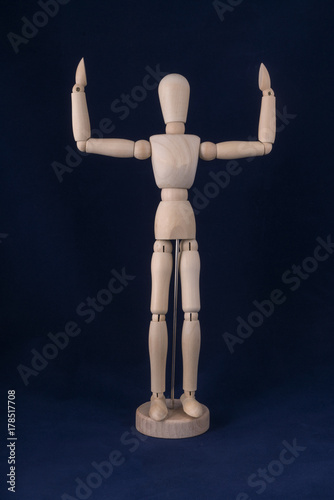 dummy with raised hands with a blue background 